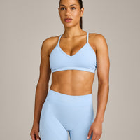 EnhanceLift™ Seamless Strappy Sports Bra with Gray Logo | Powdered Blue