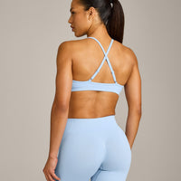 EnhanceLift™ Seamless Strappy Sports Bra with Gray Logo | Powdered Blue