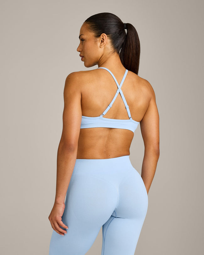 EnhanceLift™ Seamless Strappy Sports Bra with Gray Logo | Powdered Blue