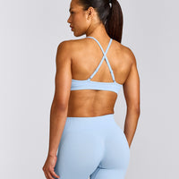 EnhanceLift™ Seamless Strappy Sports Bra with Gray Logo | Powdered Blue