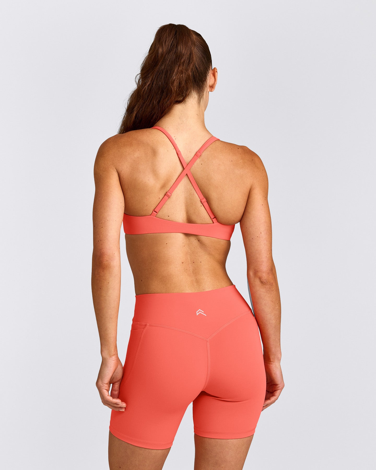UnifiedMove™ Cross Back Sports Bra with Reflective Logo | Light Charged Coral