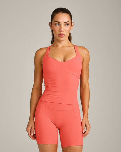 UnifiedMove™ T Back Mid Tank Top with Built in Bra Shelf with Reflective Logo | Light Charged Coral