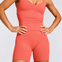 UnifiedMove™ T Back Mid Tank Top with Built in Bra Shelf with Reflective Logo | Light Charged Coral