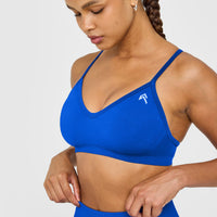 EnhanceLift™ Seamless Strappy Sports Bra with White Logo | Cobalt Blue