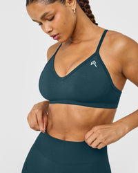 EnhanceLift™ Seamless Strappy Sports Bra with White Logo | Washed Oil Blue
