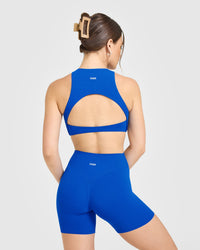 SoftMotion™ High Neck Sports Bra with White Logo | Light Cobalt Blue