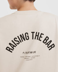Raising The Bar Graphic Unisex T-Shirt | Sand