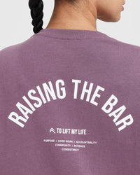 Raising The Bar Graphic Unisex T-Shirt | Vintage Purple